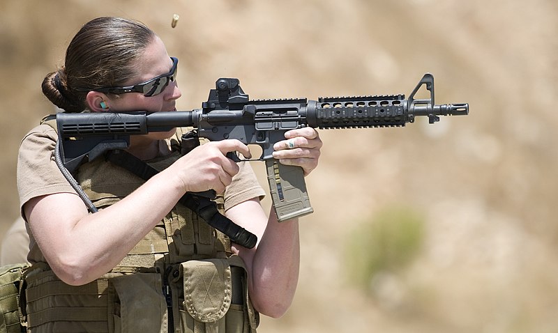 Woman shooting an ar15 at an open range class.