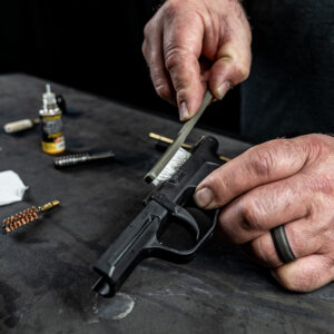 man cleaning a gun